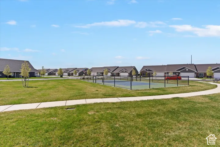 View of property's community with a tennis court and a residential view