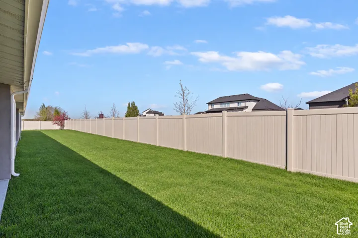 Expansive lawn area with a perimeter privacy fence