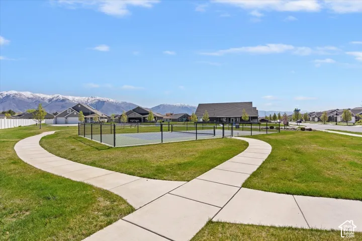 View of property's community with a tennis court and a mountain view