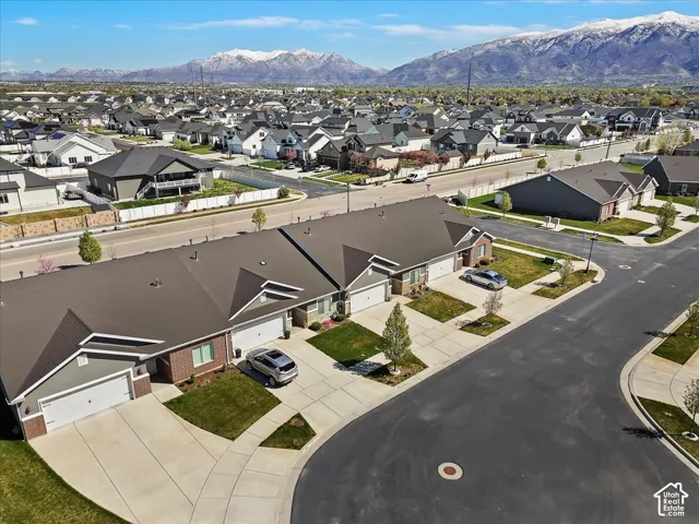 Aerial perspective of suburban area featuring a mountainous background