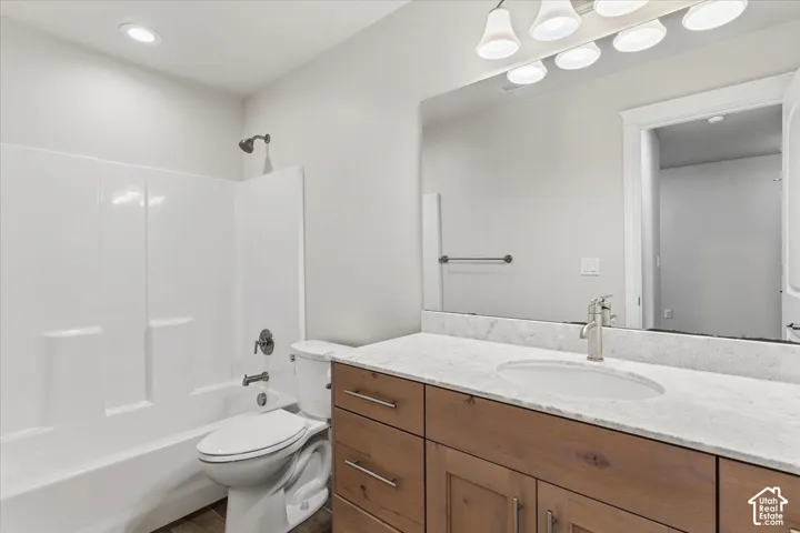 Full bath with vanity, bathing tub / shower combination, and recessed lighting