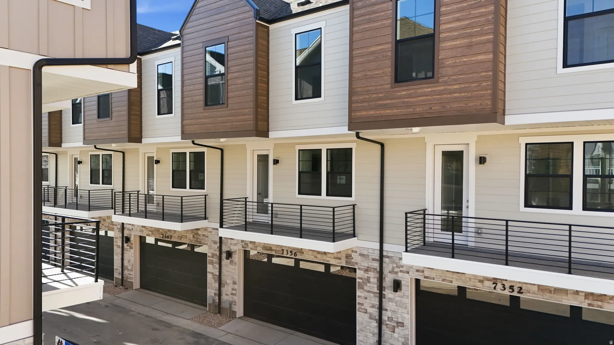 Contemporary home with an attached garage and a balcony