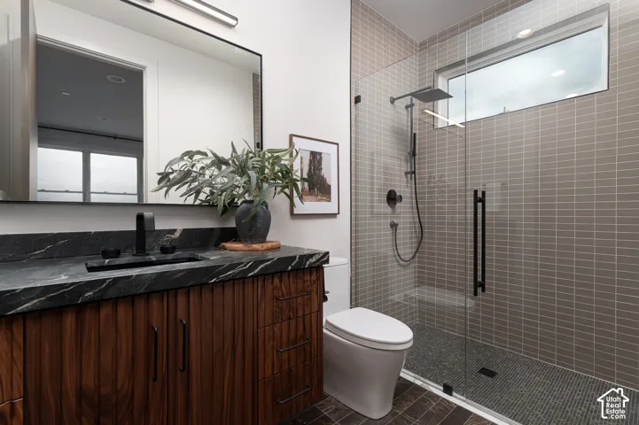 Full bathroom with vanity and a shower stall