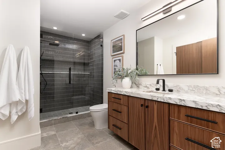 Bathroom featuring vanity, a shower stall, and recessed lighting