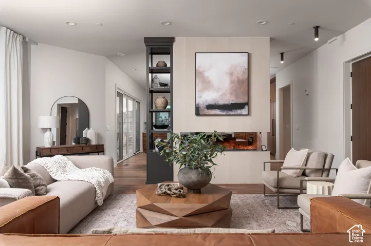 Living area with wood finished floors and recessed lighting