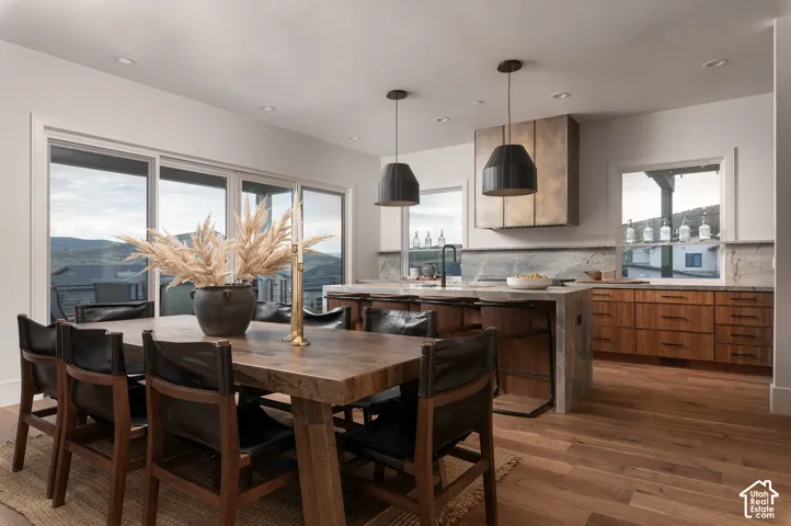 Dining room featuring dark wood-type flooring, recessed lighting, and a mountain view