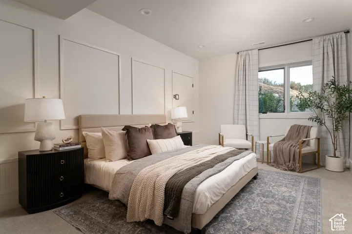 Bedroom with light carpet and recessed lighting