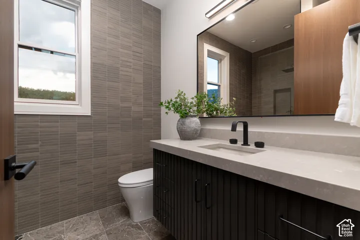 Bathroom featuring tile walls and vanity