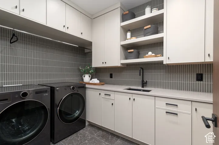 Laundry area featuring cabinet space and separate washer and dryer