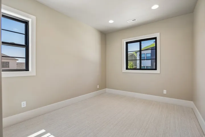 Neutral tone walls with white trim and light carpeting