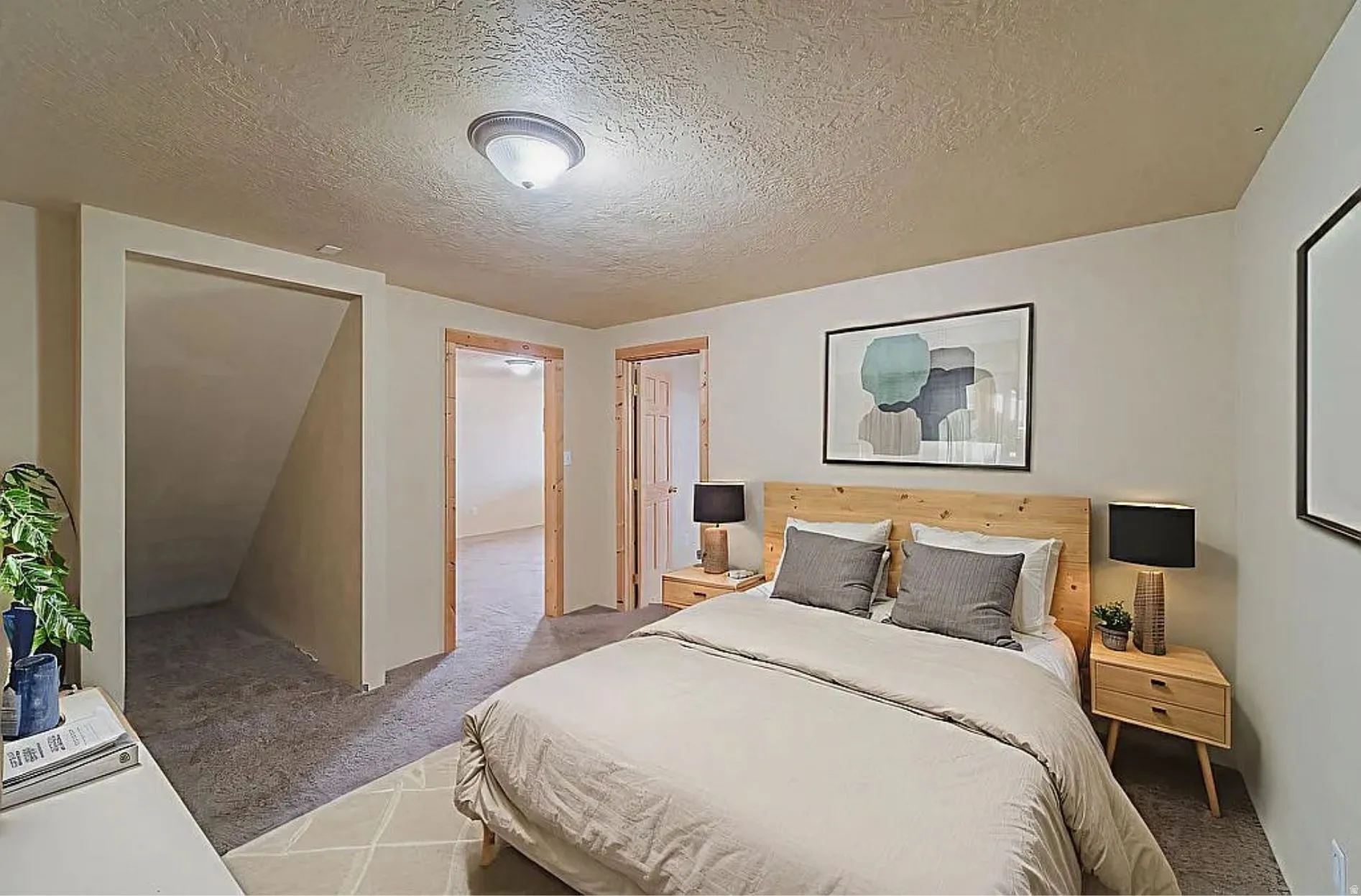 Carpeted bedroom with a textured ceiling