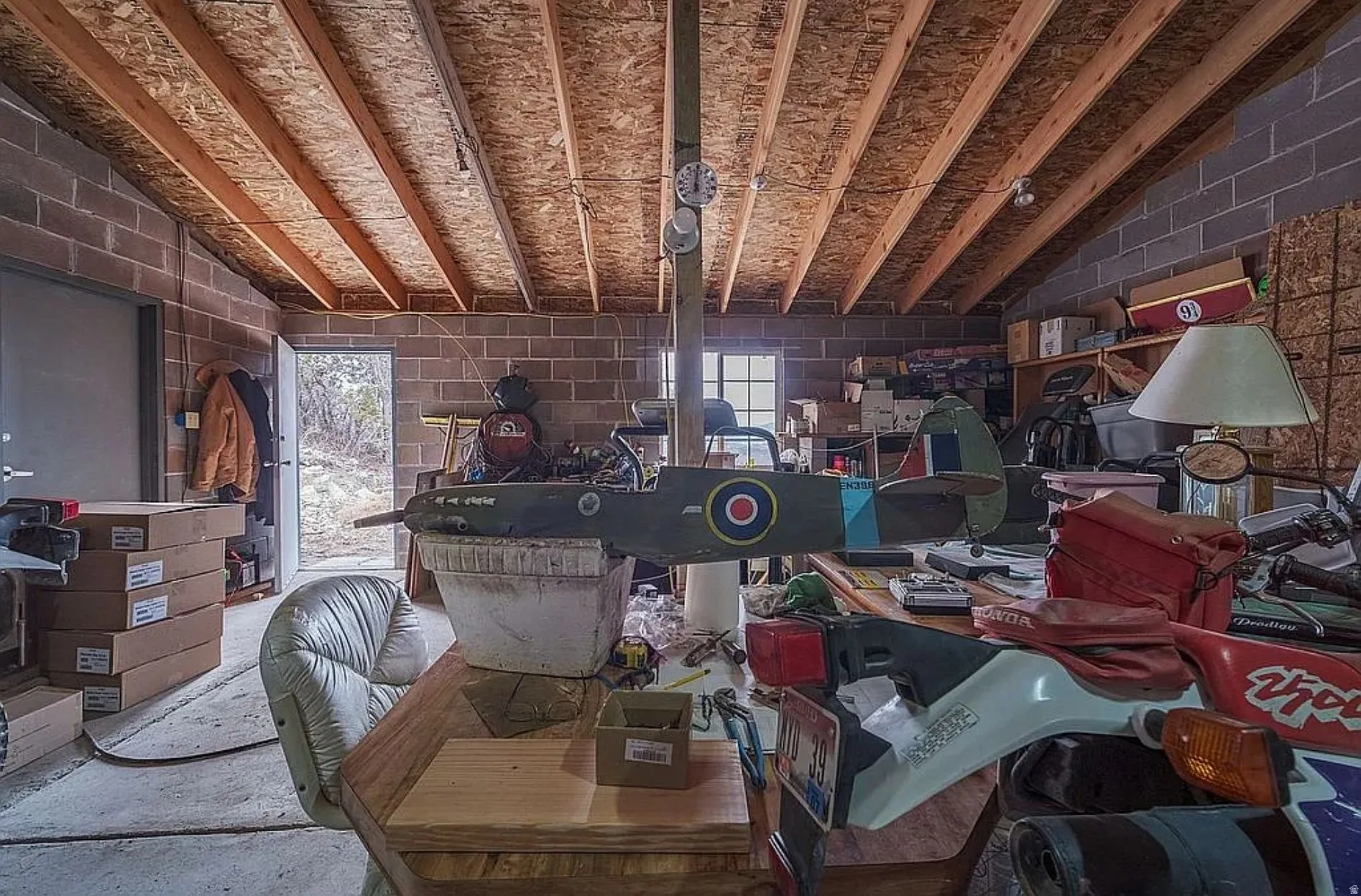 Miscellaneous room with vaulted ceiling, concrete block wall, and healthy amount of natural light