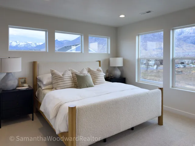 Bedroom with light carpet, recessed lighting, and a mountain view