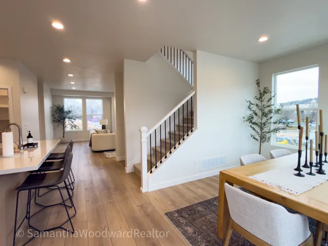 Dining room with light wood-type flooring and recessed lighting