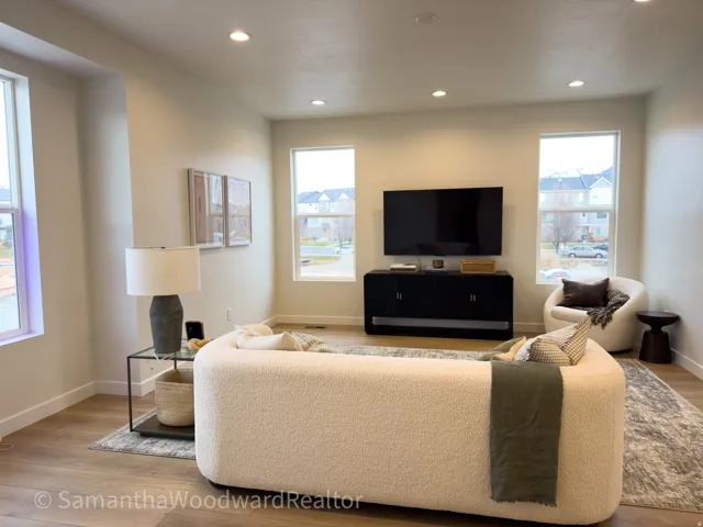 Living area featuring healthy amount of natural light, light wood finished floors, and recessed lighting