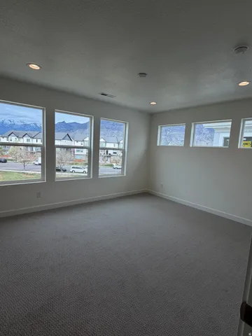 Unfurnished room featuring recessed lighting, carpet flooring, a textured ceiling, and a smoke detector