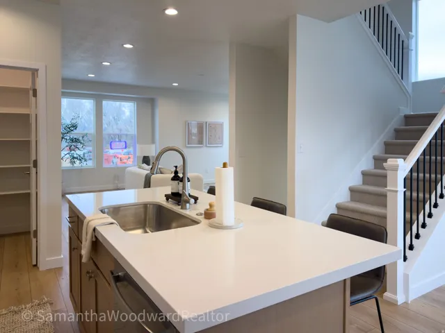 Kitchen with a kitchen breakfast bar, an island with sink, light wood-style flooring, and recessed lighting