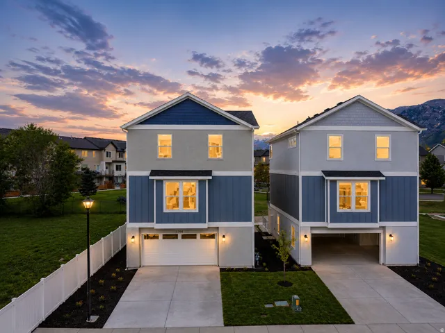 Two-story residential structures featuring contemporary two-tone siding, attached garages, and concrete driveways