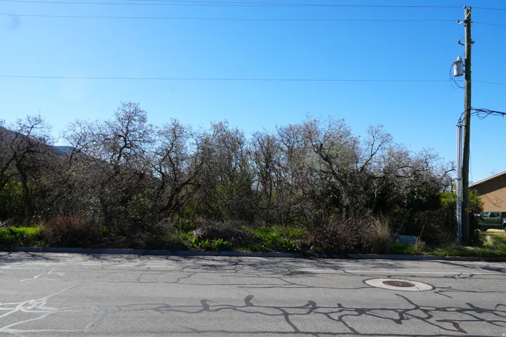 View of asphalt road with curbs