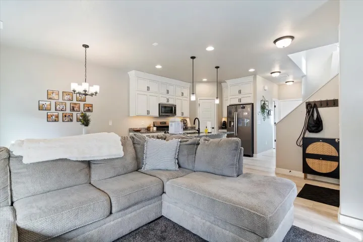 Living area featuring light wood-type flooring and a chandelier
