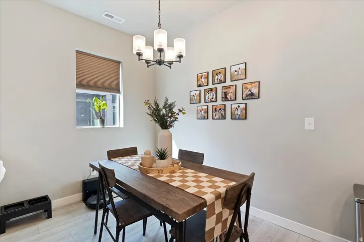 Dining area featuring light wood finished floors and suspended lighting