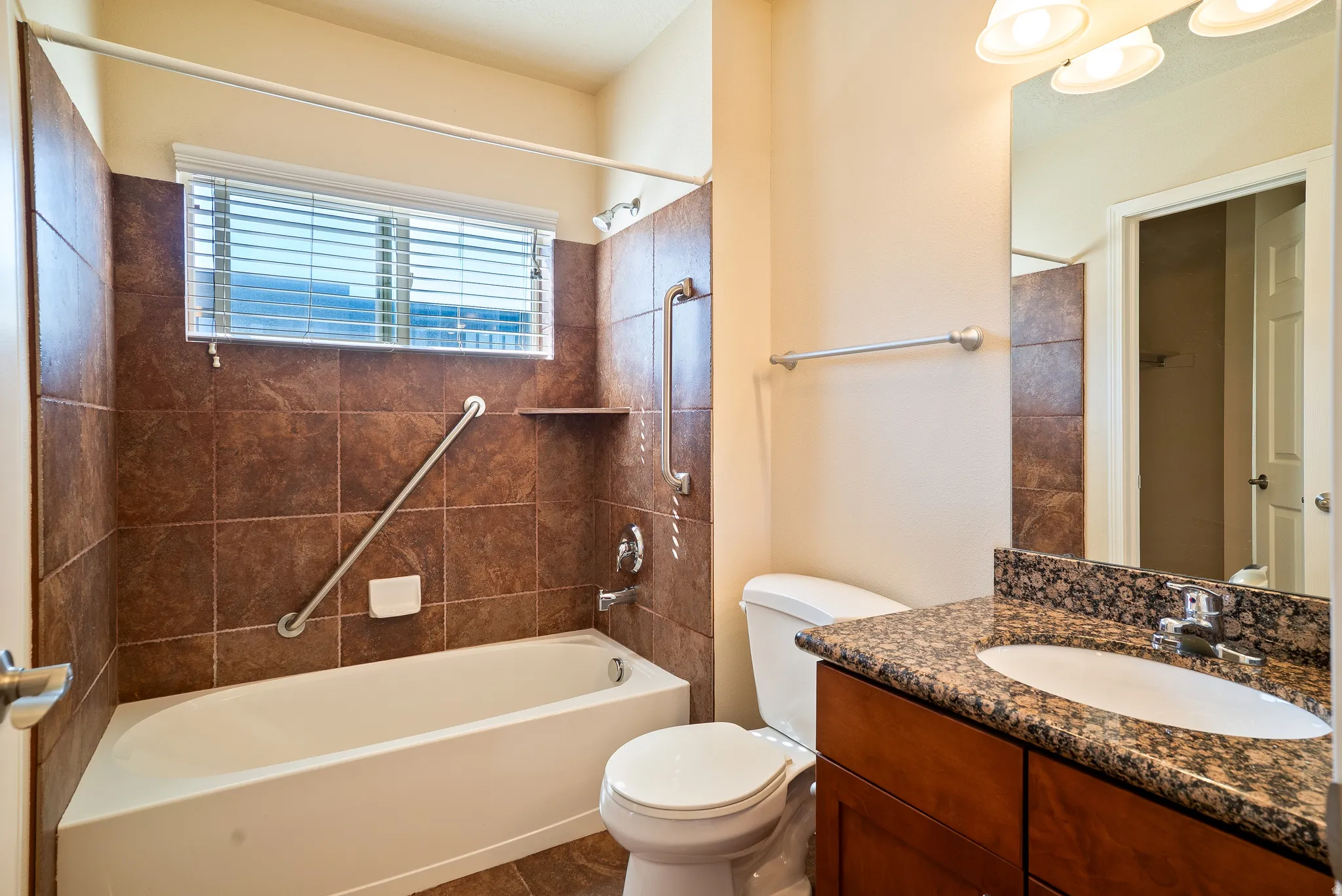 Full bath featuring vanity and shower / bath combination
