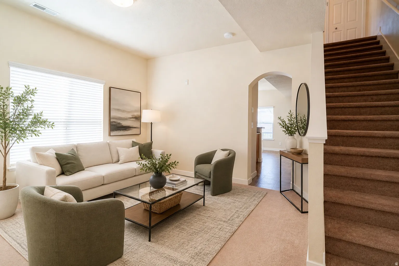 Living room with arched entry to kitchen