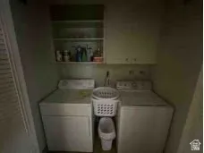 Laundry room featuring washing machine and dryer and cabinet space