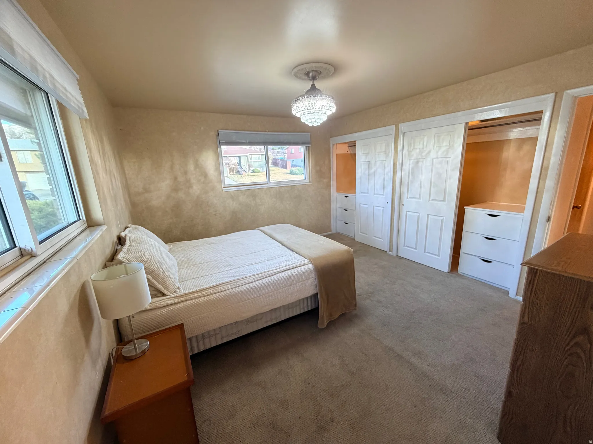 Carpeted bedroom with two closets