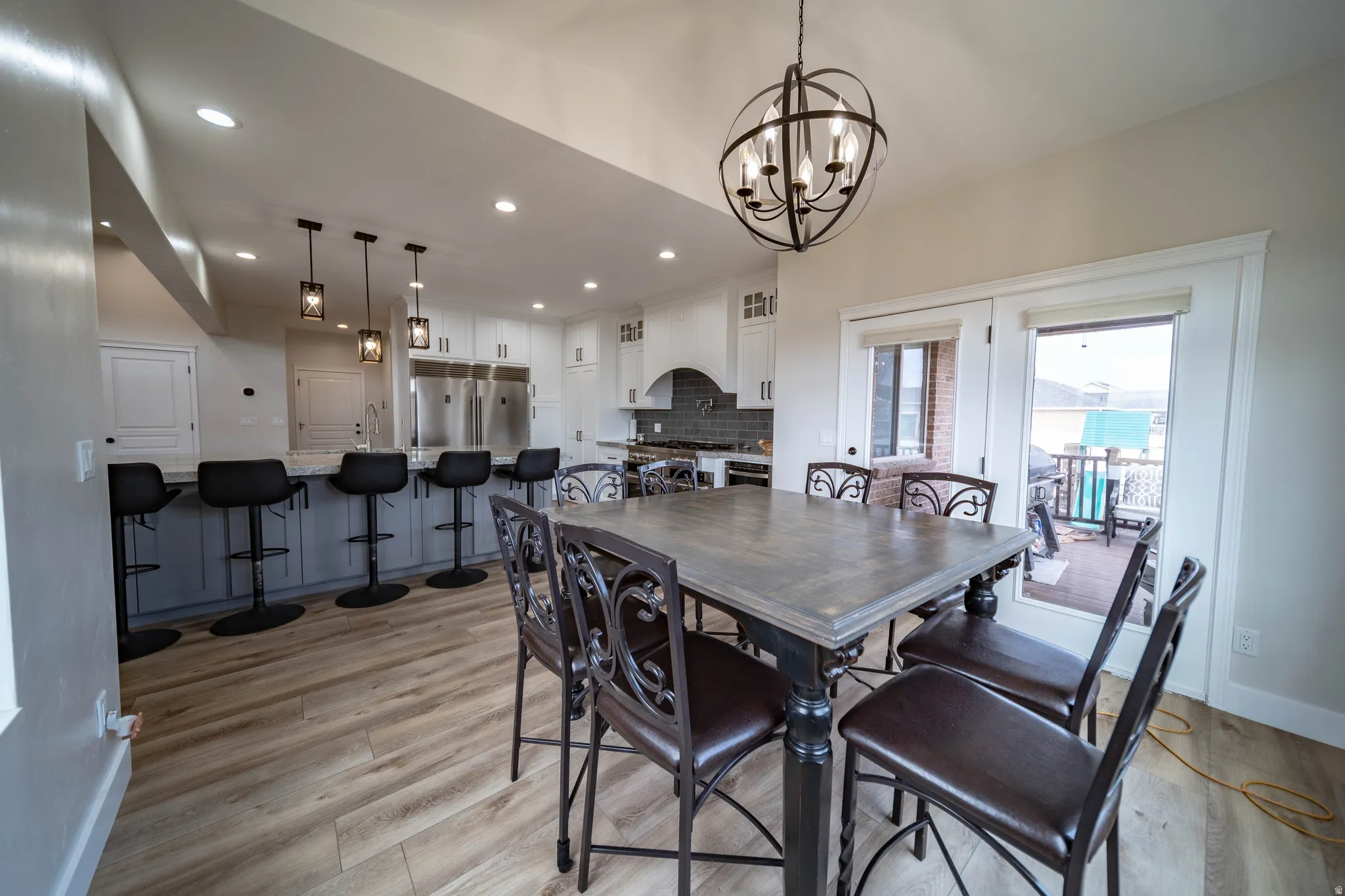 Dining room with light wood finished floors and a chandelier