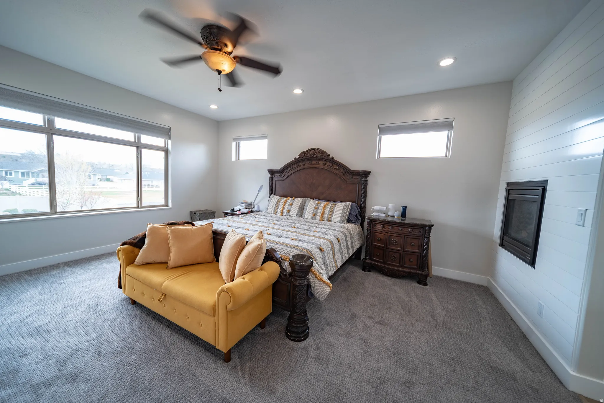 Bedroom with carpet, recessed lighting, ceiling fan, and multiple windows