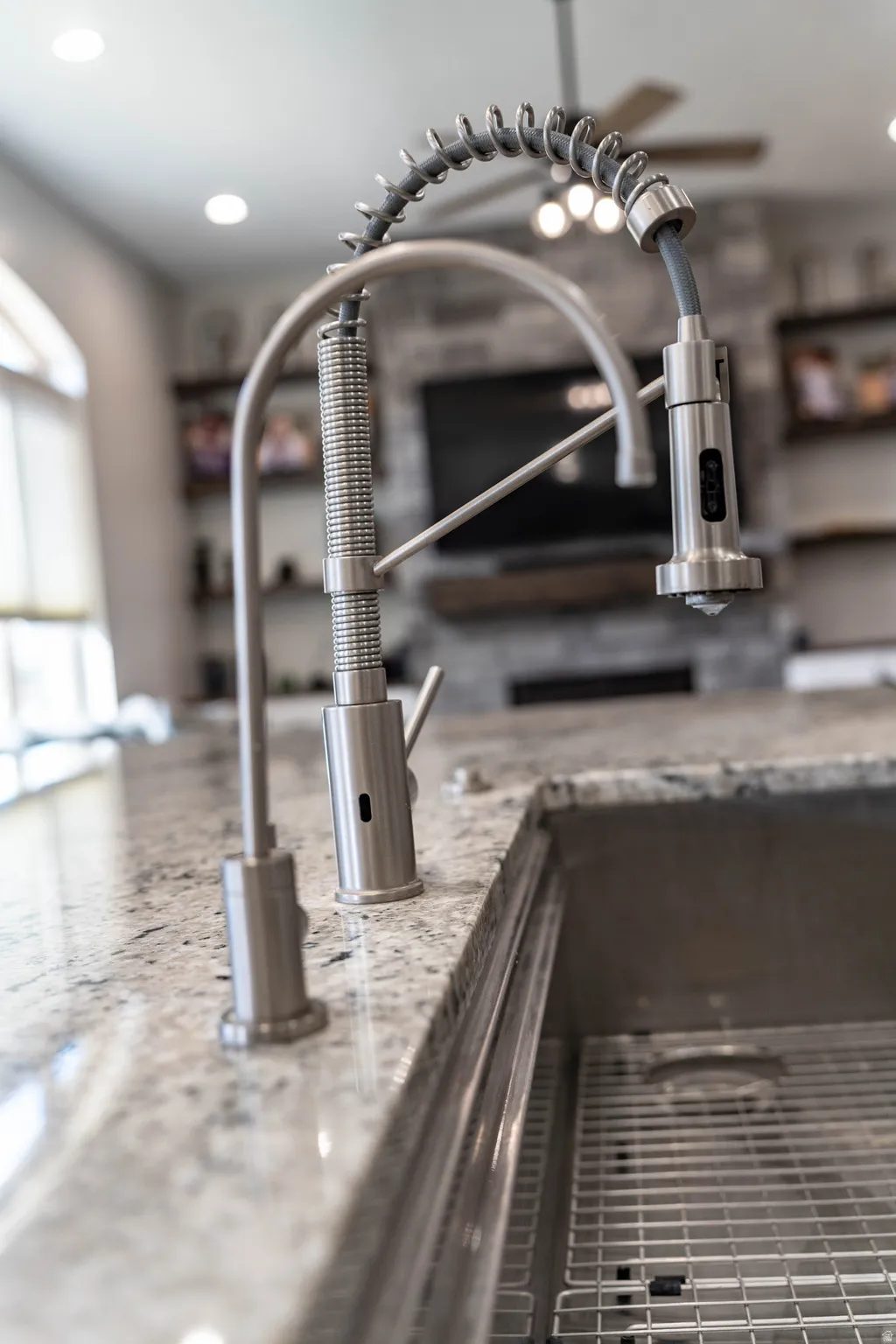 Kitchen view of recessed lighting, open shelves, and light stone counters