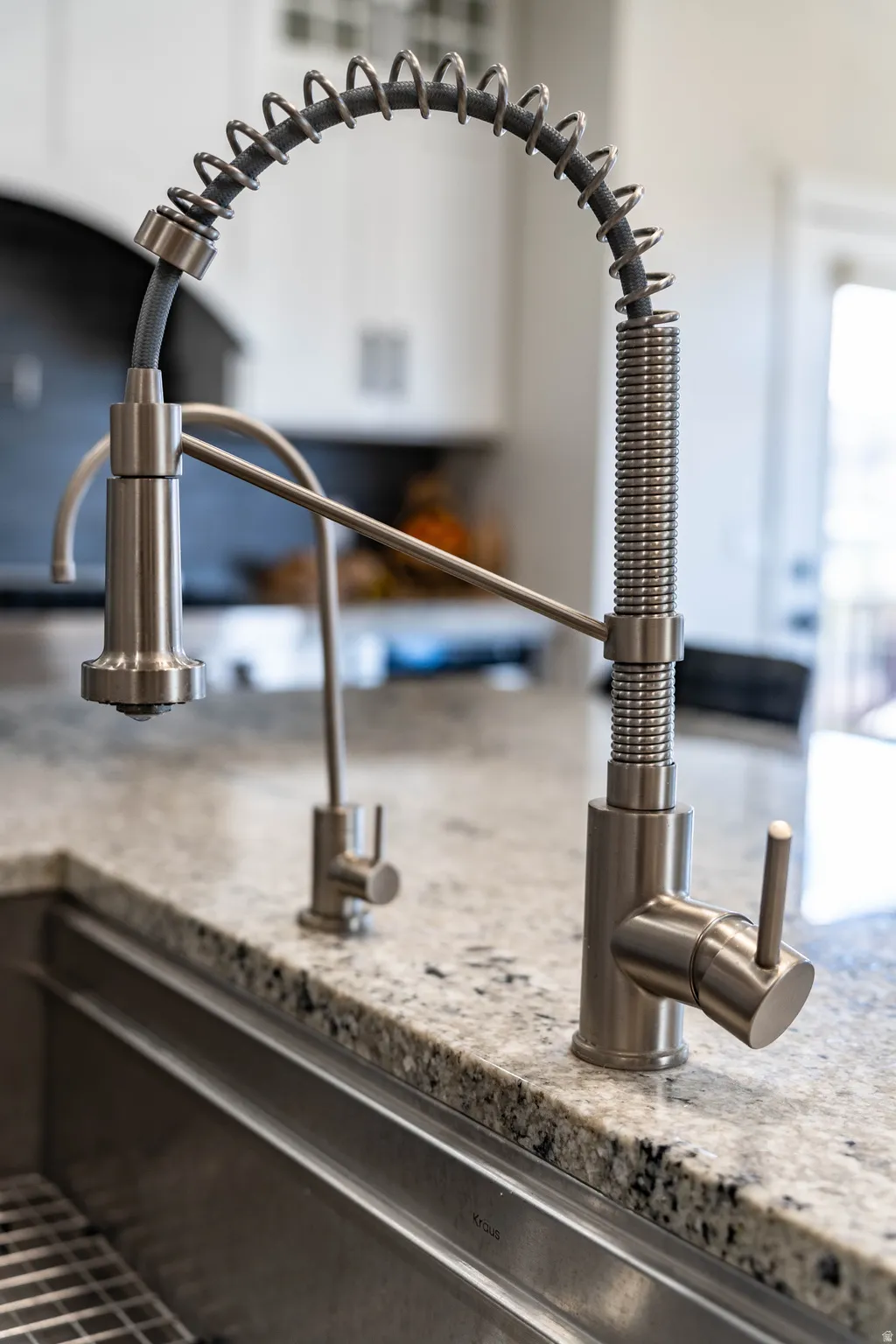 Kitchen view of a sink and light stone countertops