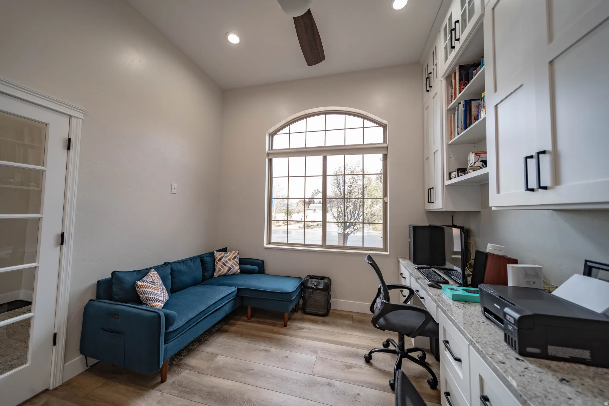 Office featuring ceiling fan, built in desk, light wood-style floors, and recessed lighting