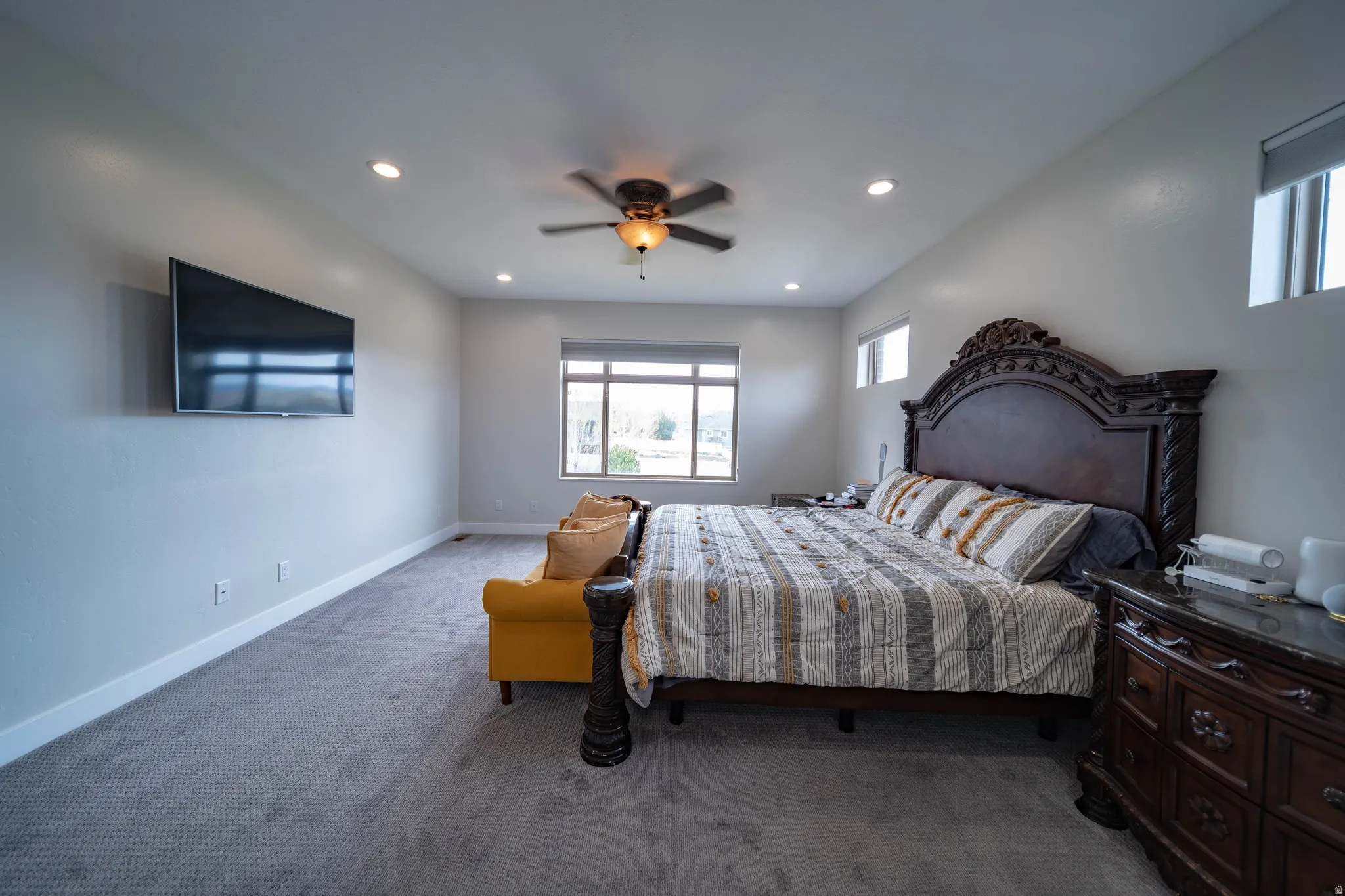 Bedroom featuring carpet floors, ceiling fan, and recessed lighting