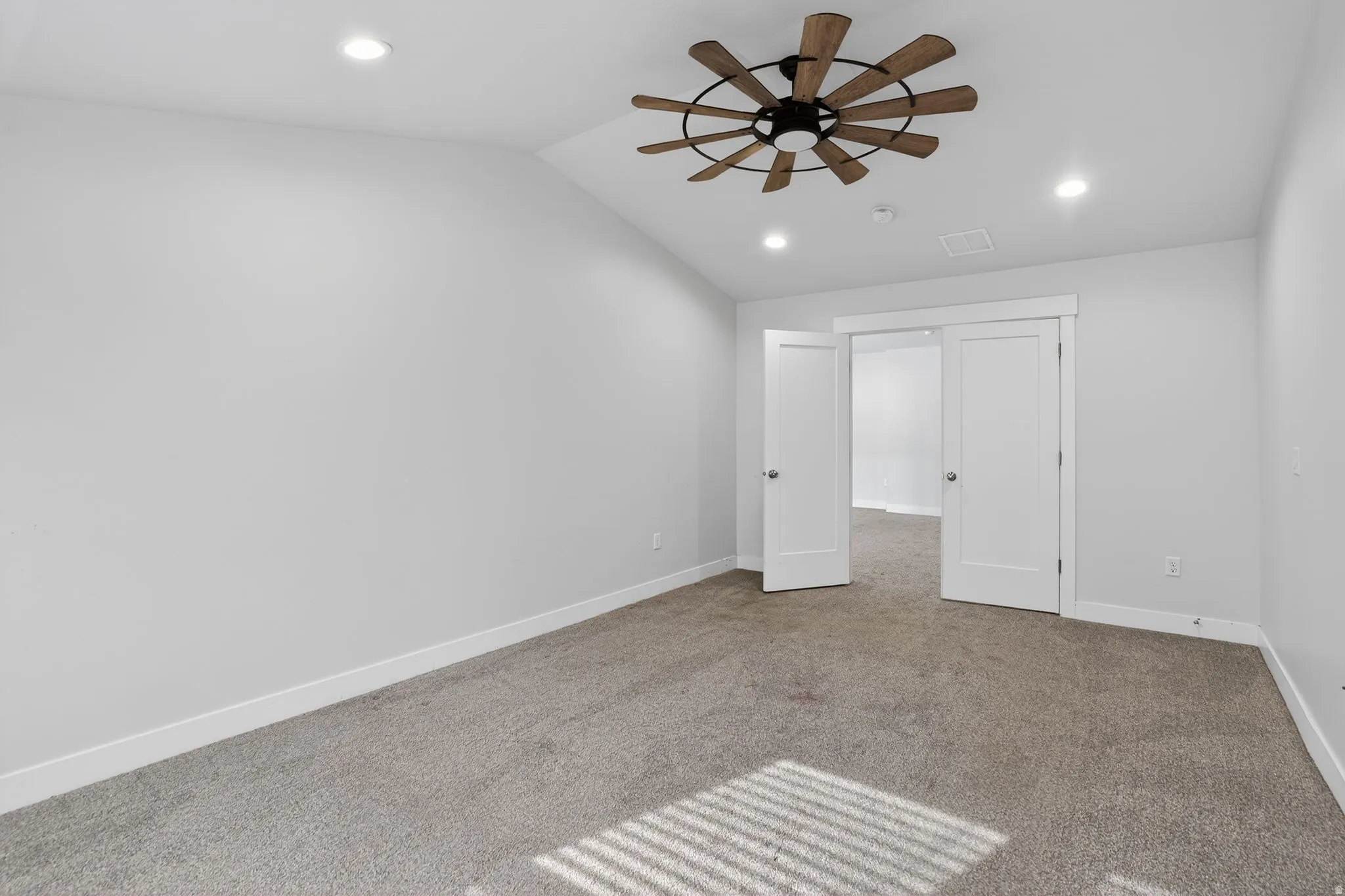 Unfurnished bedroom with carpet flooring, lofted ceiling, recessed lighting, and ceiling fan