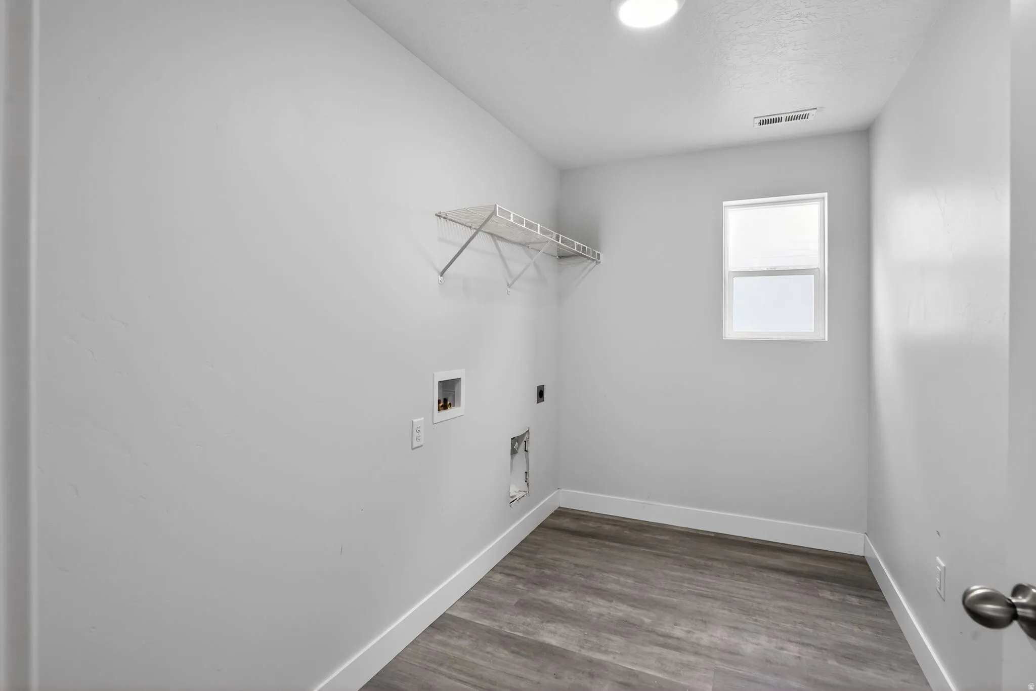 Laundry area featuring electric dryer hookup, dark wood-style floors, and hookup for a washing machine