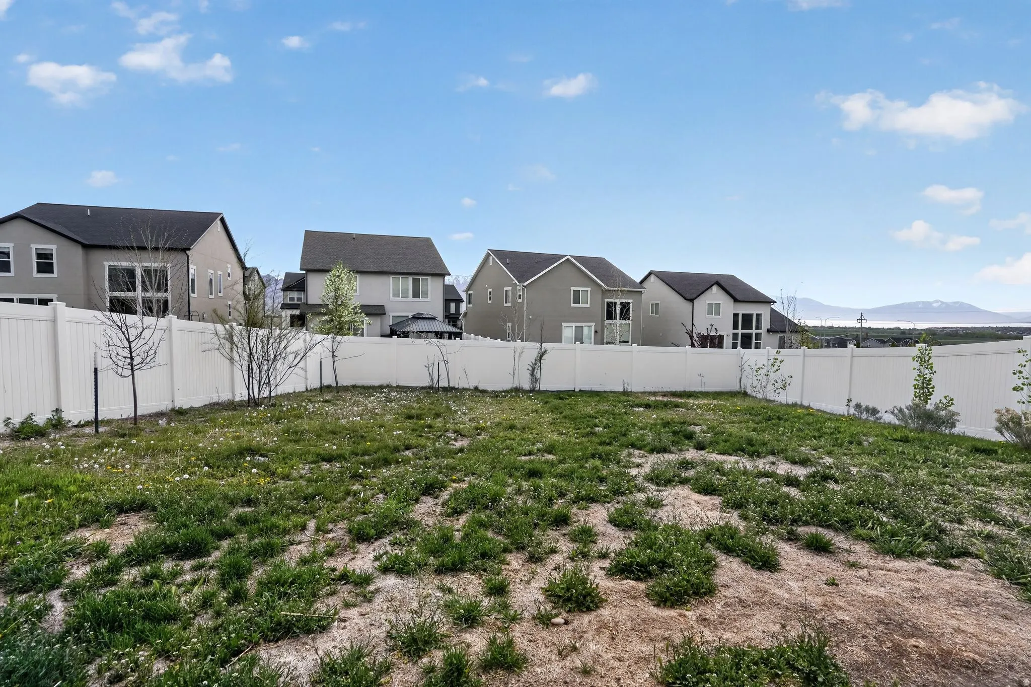 Fenced backyard with a mountain view and a residential view