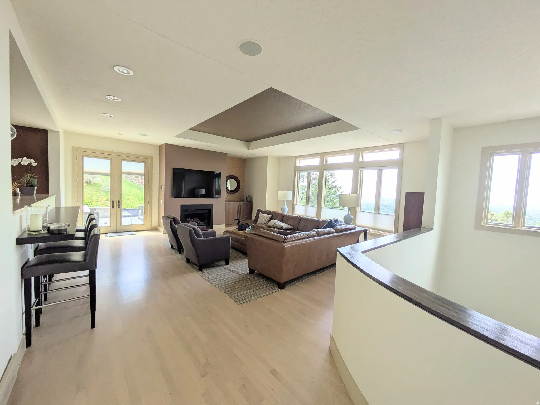 Light wood-finish flooring extends through this open-concept living area