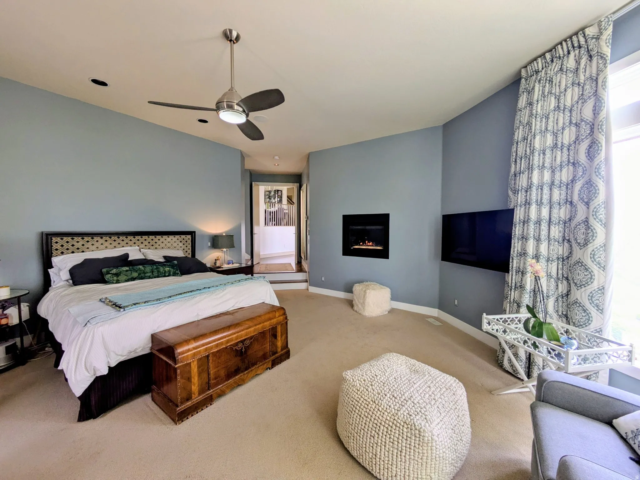 Carpeted Master bedroom featuring a built-in fireplace, recessed lighting, and a ceiling fan