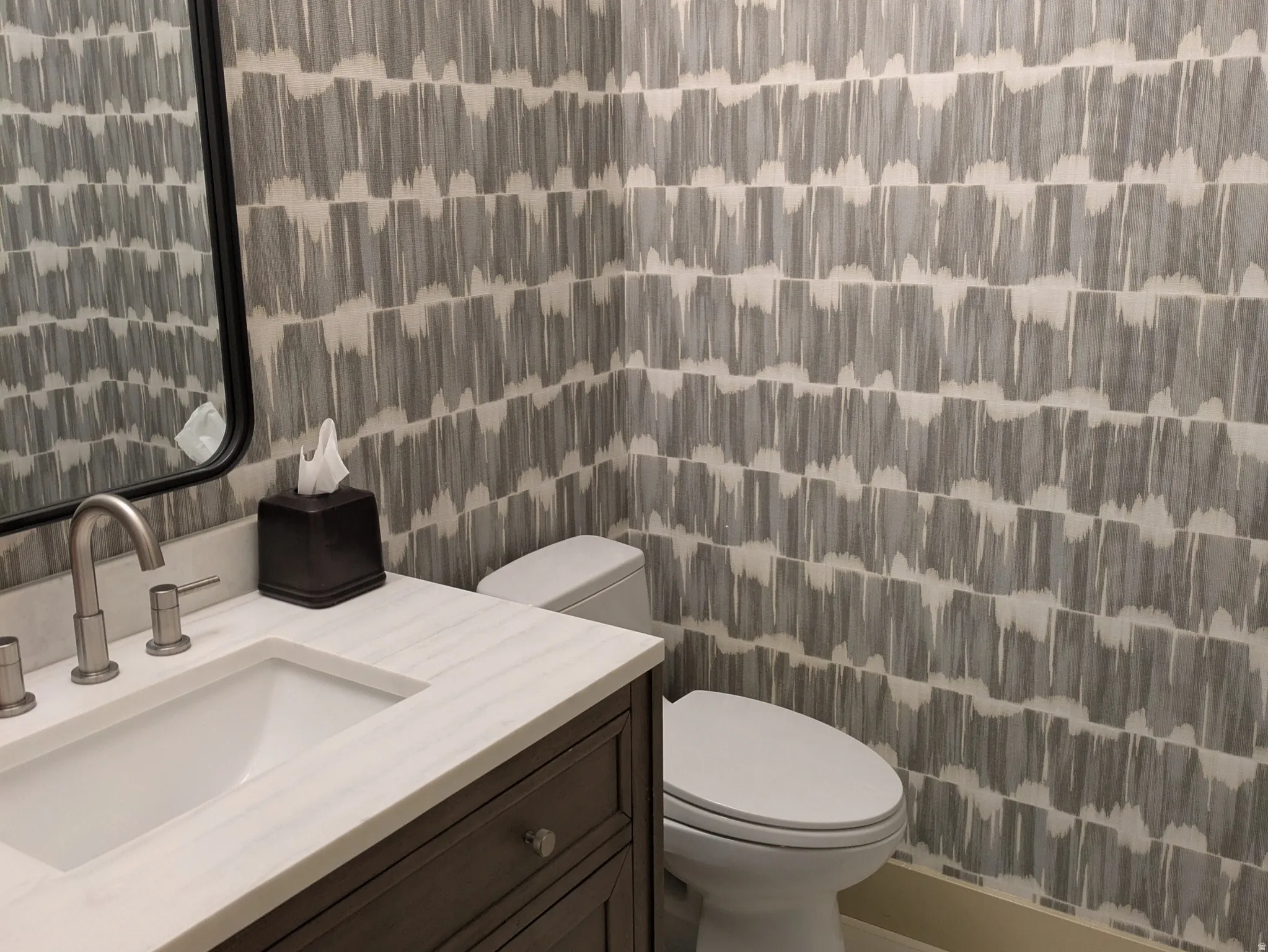 Half bathroom featuring vanity and light tile patterned floors