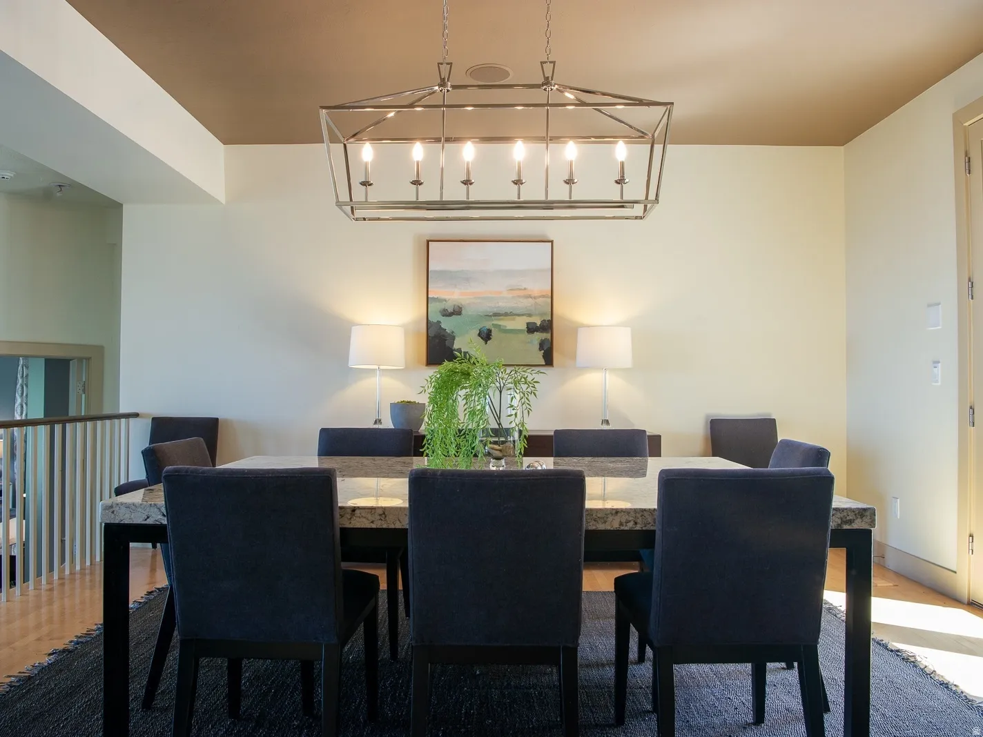 Dining space with light hardwood flooring and French doors to deck.