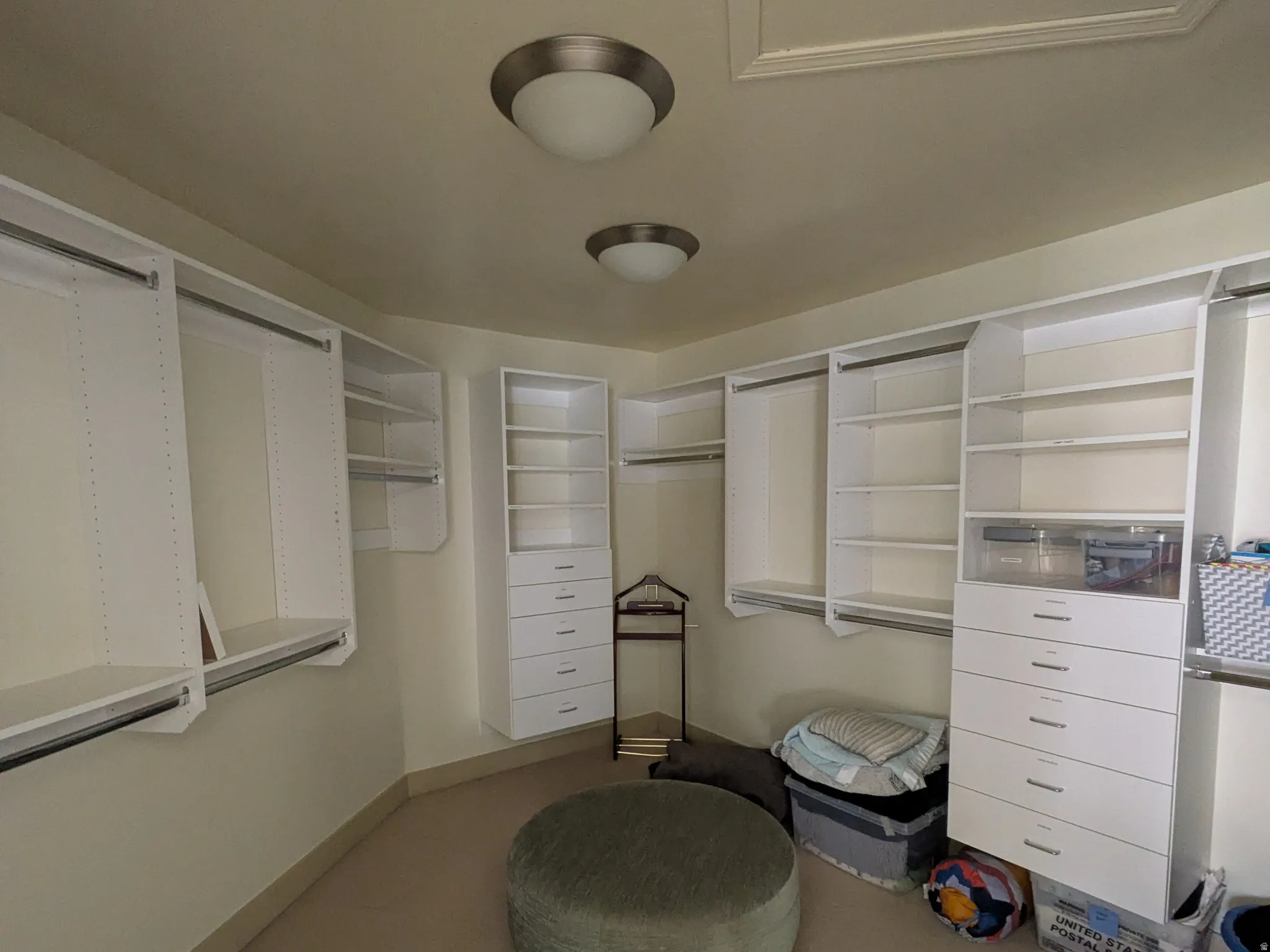 Walk in Master closet featuring carpet floors and so much storage