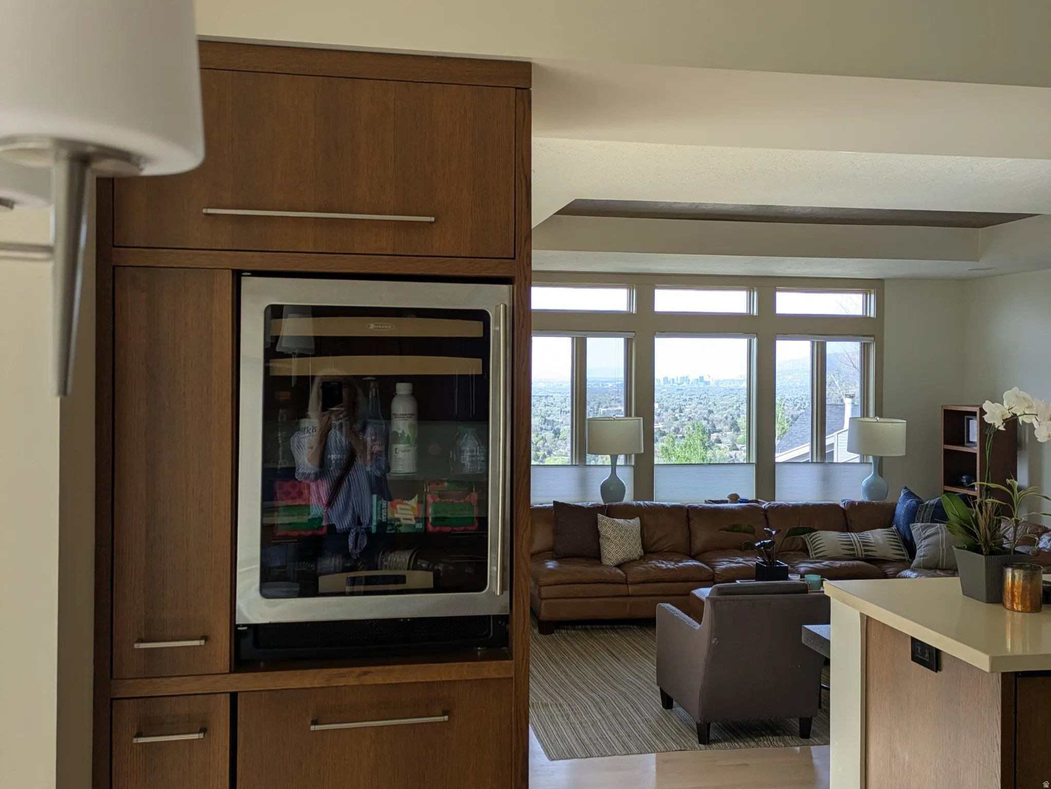Kitchen with wine cooler, light wood-style floors, open floor plan, and wood finish cabinets