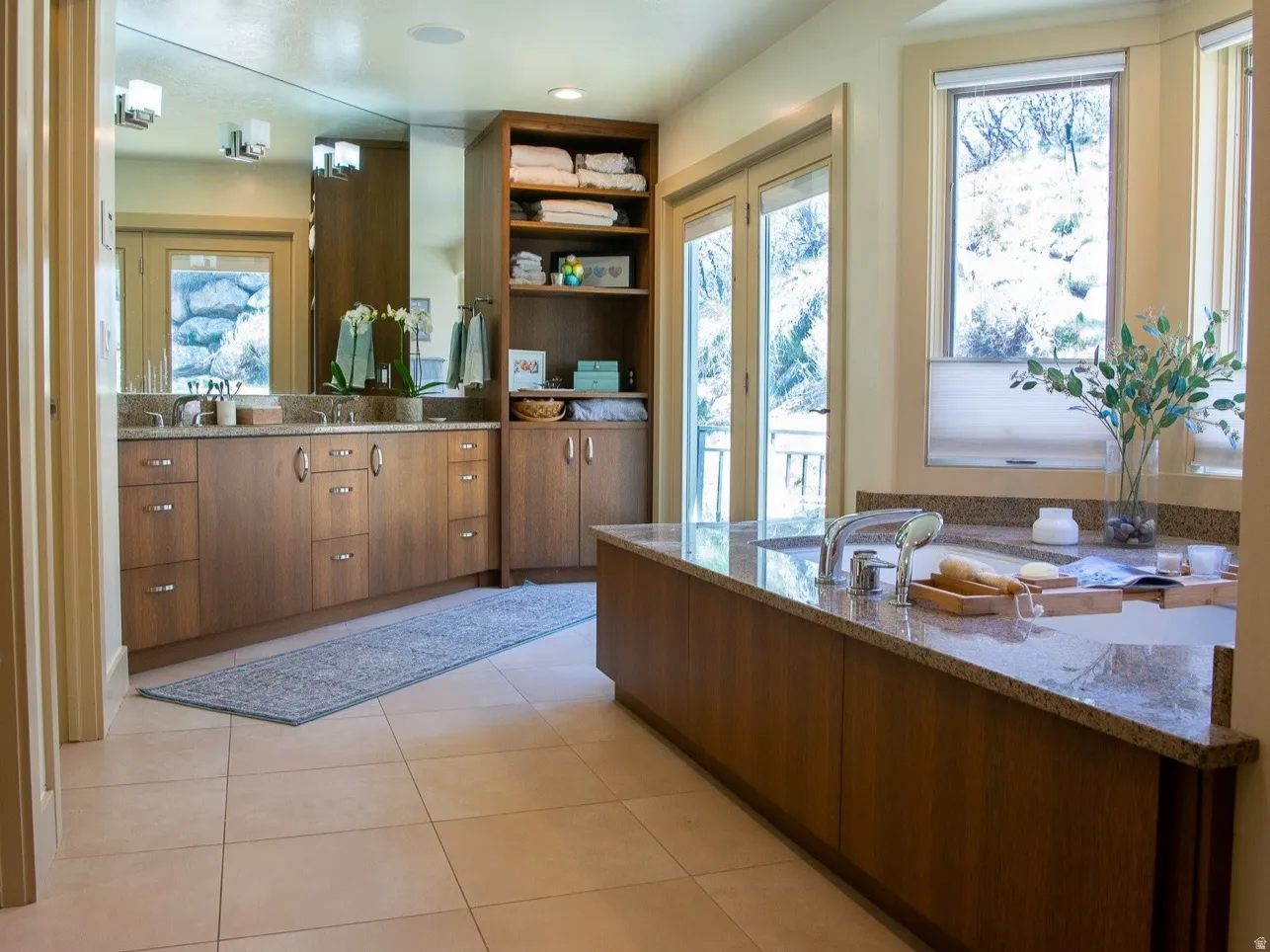 Full bathroom with separate tub and shower. Double sinks vanity and light tile patterned flooring. Spectacular view and deck.