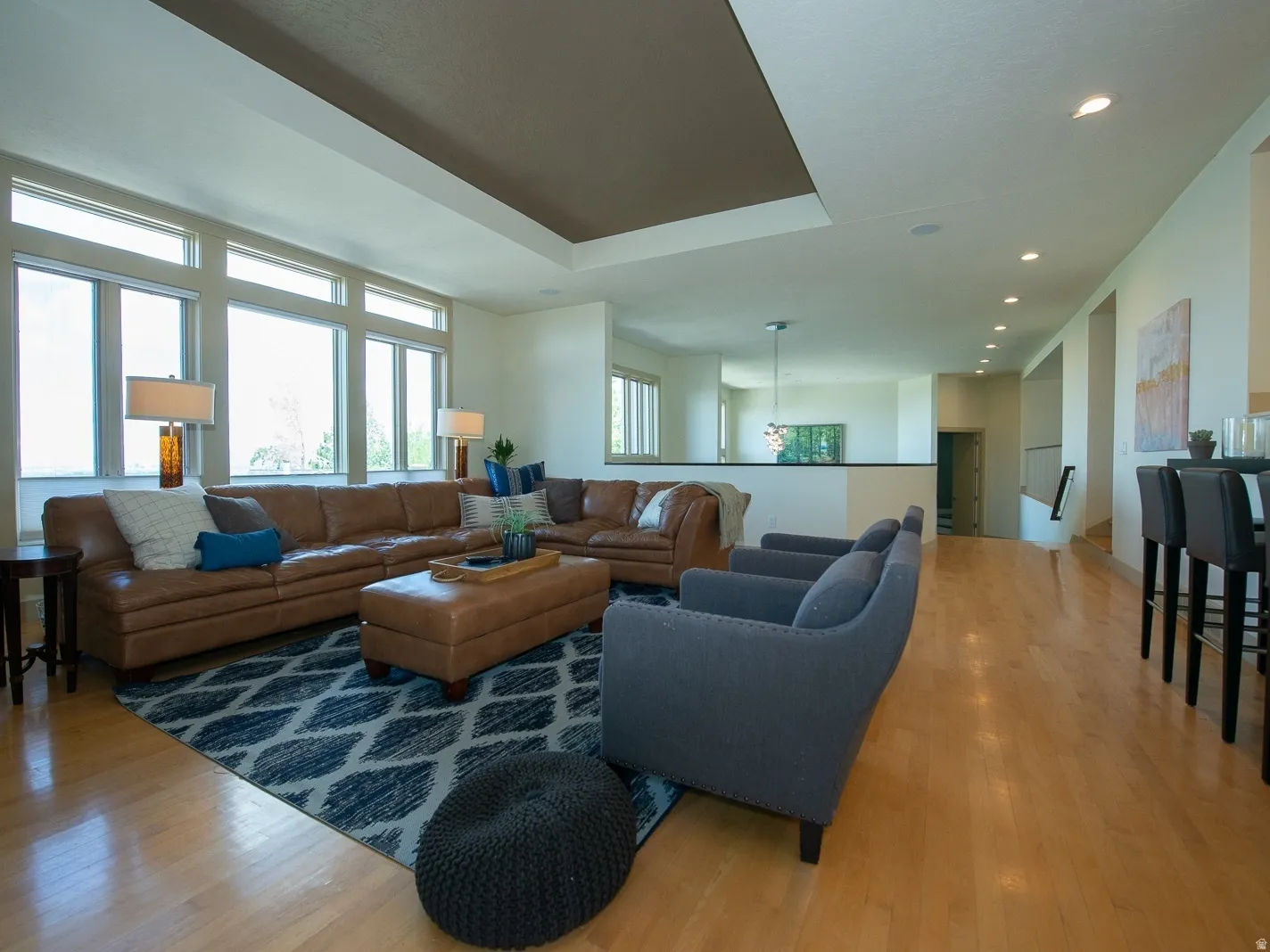 Open floor plan to this lovely family room with hardwood flooring, recessed lighting and expansive views