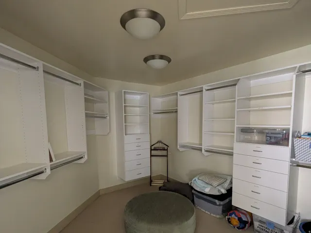 Walk in Master closet featuring carpet floors and so much storage