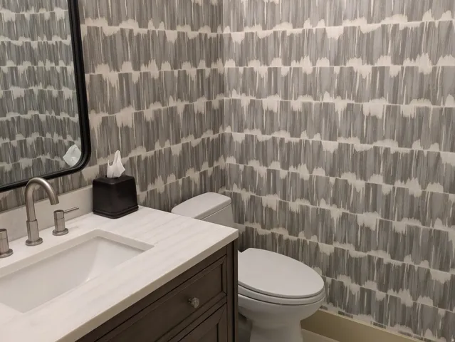 Half bathroom featuring vanity and light tile patterned floors