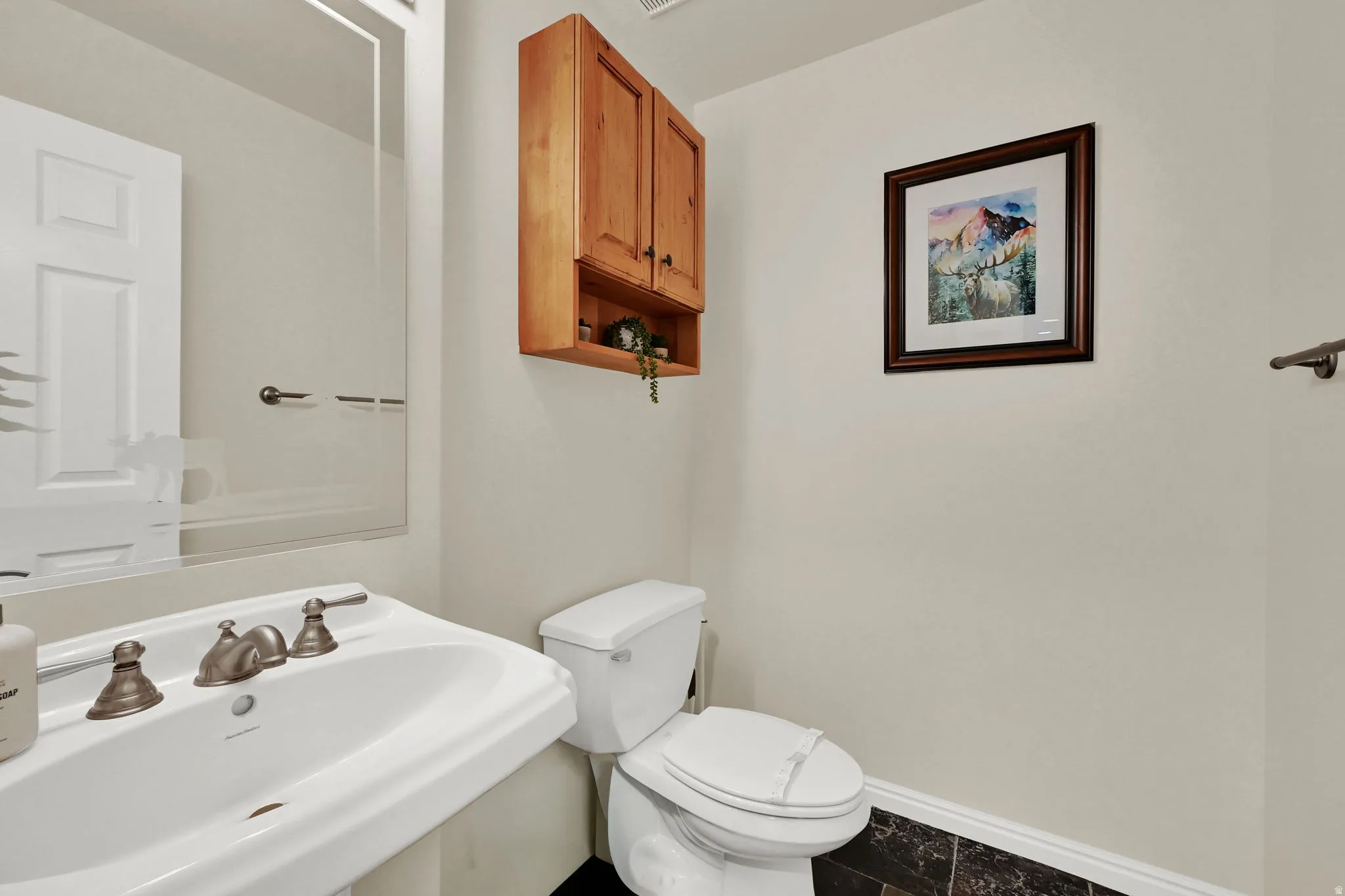 Half bathroom featuring a sink and toilet