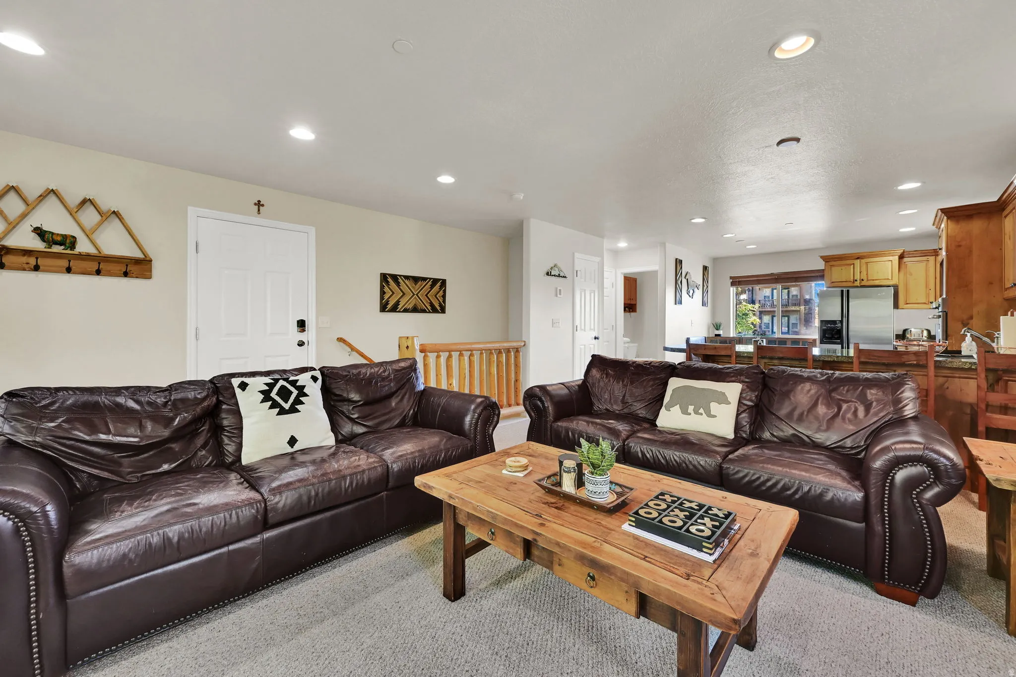 Living room with recessed lighting and light carpet